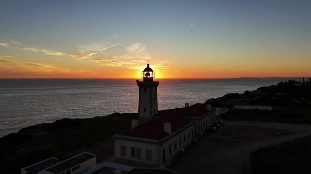 Sunset through Lighthouse glass. Drone in and out.