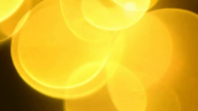 Abstract video with yellow bokeh effect. Bright color spots. Footage. Place holder.