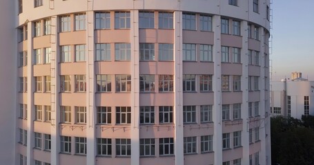 Fototapeta premium A Modern Round Building featuring Glass Windows beautifully situated at Sunset for scenic views. Stock Clip