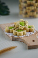 Indonesian mint cookies photographed on a white table with a wooden theme in an indoor studio