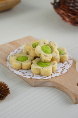 Indonesian mint cookies photographed on a white table with a wooden theme in an indoor studio