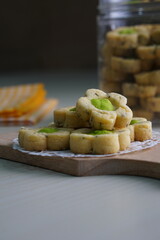 Indonesian mint cookies photographed on a white table with a wooden theme in an indoor studio