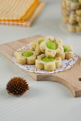Indonesian mint cookies photographed on a white table with a wooden theme in an indoor studio