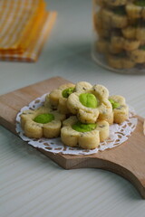 Indonesian mint cookies photographed on a white table with a wooden theme in an indoor studio