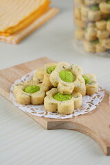 Indonesian mint cookies photographed on a white table with a wooden theme in an indoor studio