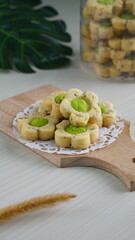 Indonesian mint cookies photographed on a white table with a wooden theme in an indoor studio