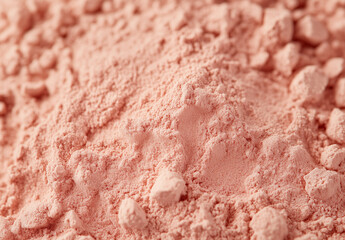 Pink clay cosmetic texture on the background, close-up. Background of smudged cream for face or body mask. Close-up of a pink creamy swatch.