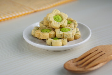 Indonesian mint cookies photographed on a white table with a wooden theme in an indoor studio