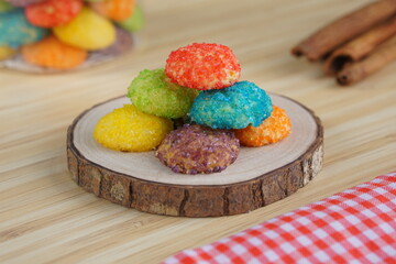 Indonesian colorful granulated sugar sprinkled biscuits photographed with a wooden theme in an indoor studio