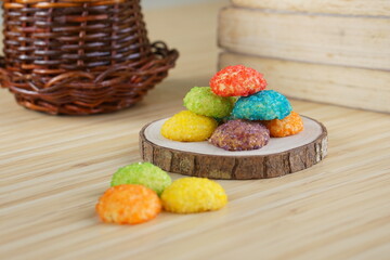 Indonesian colorful granulated sugar sprinkled biscuits photographed with a wooden theme in an indoor studio