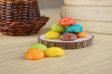 Indonesian colorful granulated sugar sprinkled biscuits photographed with a wooden theme in an indoor studio