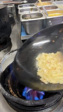 wok cooking, making Thai stir fried noodles (pad see ew)