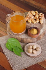 herbal drink made from turmeric, betel leaves and oak galls photographed in a studio setting with...