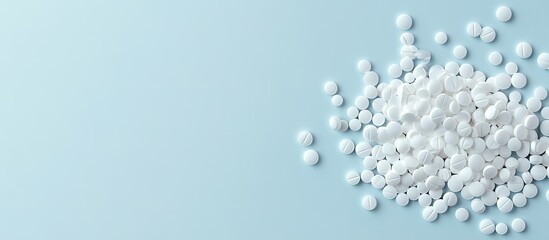 Pile of White Pills on Light Blue Background