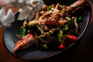 mixed salad with grilled seafood : shrimps, calamari, prawns as perfect healthy  balanced food for mediterranean diet