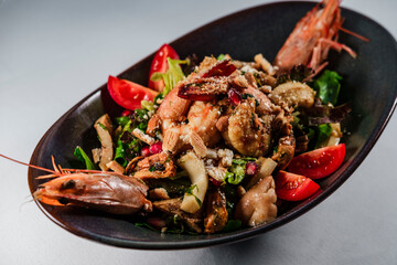 mixed salad with grilled seafood : shrimps, calamari, prawns as perfect healthy  balanced food for mediterranean diet on white background