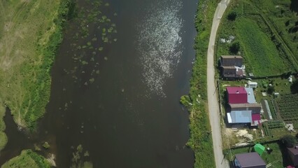 Stunning Aerial View of a Serene River Flowing Through Houses Nestled in a Lush Landscape. Clip