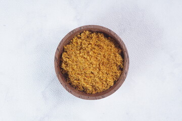 "Sambal Lingkung" is a typical food from Palembang, Indonesia. namely a type of floss made from catfish meat, in a wooden bowl photographed in the studio with a wooden theme prop