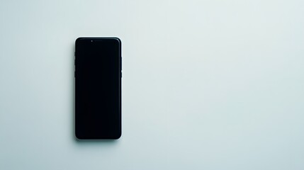 Naklejka premium A sleek black smartphone lying flat on a white surface