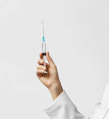 Healthcare professional holds syringe in hospital setting for vaccination process
