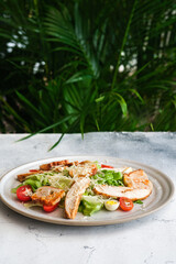 Presented on a rustic wooden round board, this Caesar salad creates a visually striking contrast between the classic ingredients and the modern presentation.