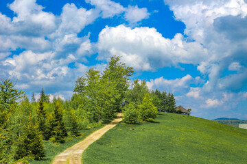 Panorama of mountains, mountain shelter in the Silesian Beskids, Telesforówka, wreck of an old abandoned car as an attraction for tourists