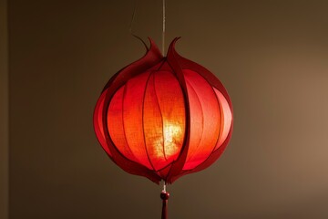 Obraz premium Red paper lantern hanging from the ceiling, emitting a warm, soft light, creating a cozy atmosphere