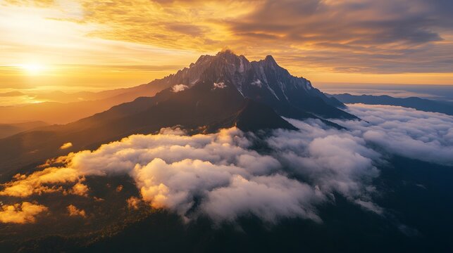 Aerial shot of Mount Kinabalu glowing under the golden sunrise, with its rugged peaks surrounded by dense clouds, in 4K resolution