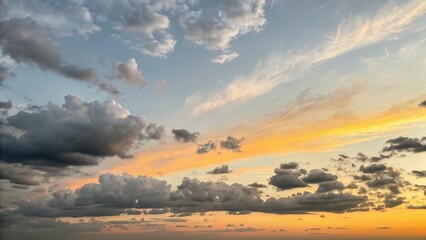 Obraz premium Minimalist Gray, Yellow, and Orange Sky with Clouds - Stock Photo