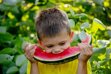 The child eats watermelon in the summer. Selective focus