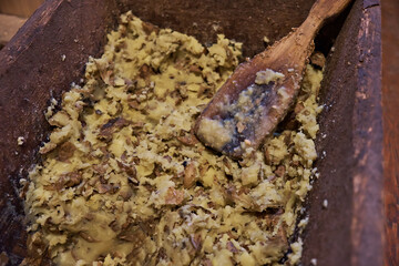 Boiled potatoes, mashed as feed for pigs in the village. Side view