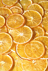Handmade dried oranges. Frips, chips, orange snacks. Bright, orange background of sliced oranges
