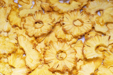 Close-up of dry pineapple rings. Fruity background, healthy food. Frips, chips, pineapple snacks, selective focus