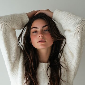 brunette woman long hair in a white sweater on a white background
