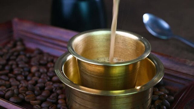 Serving Indian filter coffee in a cup.