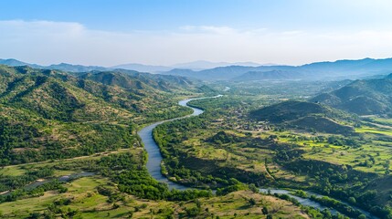 Aerial view of Pe lush Swat River winding Prough green valleys under a clear blue sky, in 4K resolution