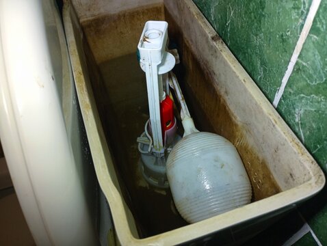 Carrying out plumbing work on repairing a toilet drain. Repairing a white toilet.