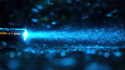 Light Beam. Blue LED flashlight beam with dust particles glowing in da