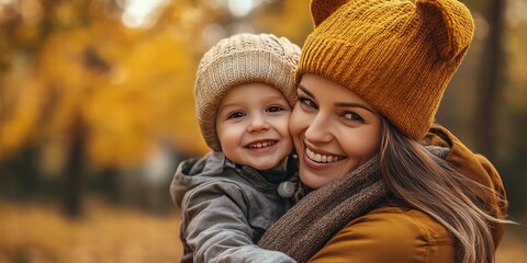 Fototapeta premium Joyful young family enjoying a beautiful autumn nature stroll. The mother, in an ear flapped hat, engages with her son in a doctor game. The little boy smiles, embodying the family concept.