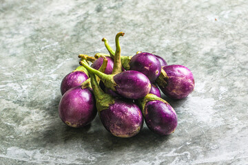 Small organic young purple round eggplant