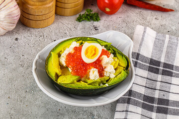Avocado with red caviar and quil egg