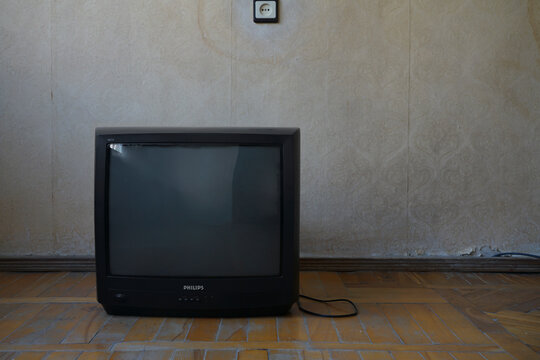 YEREVAN, ARMENIA - MAY 05, 2022: brand trade mark Philips. Vintage Retro CRT Television standing on Wooden floor 90s 80s Inspired Living empty Space. retro tv television at room background. copy space
