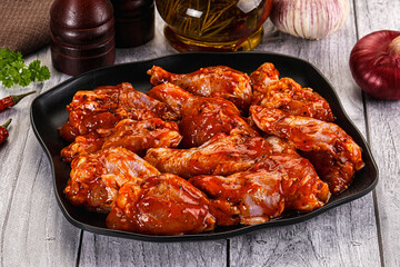 Raw marinated buffalo chicken wings