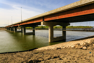 A bridge over a river with a lot of rocks and dirt