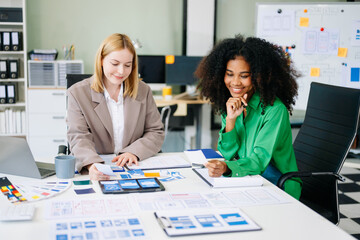 UX developer and ui designer brainstorming about mobile app interface wireframe design