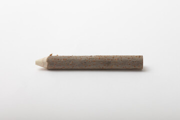Close-up of a natural pencil made from a carved tree branch