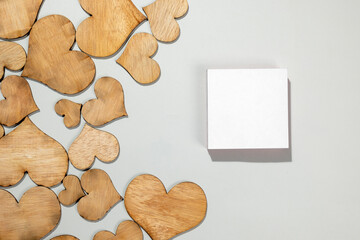Wooden hearts with empty white paper on a white background
