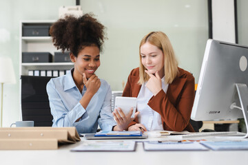 Diverse professionals collaborate on project analysis with financial graphs. Strategic teamwork and insights drive company growth and success.