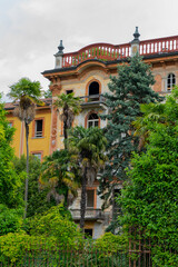 An Abandoned Mansion Beautifully Surrounded by Lush Greenery and Tall Palm Trees