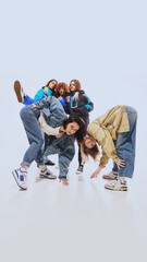 Nostalgic vibe. Young people in their 20s wearing 90s style urban outfits and posing with against...